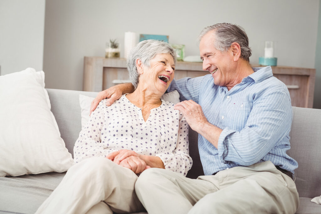 An elderly couple smiling