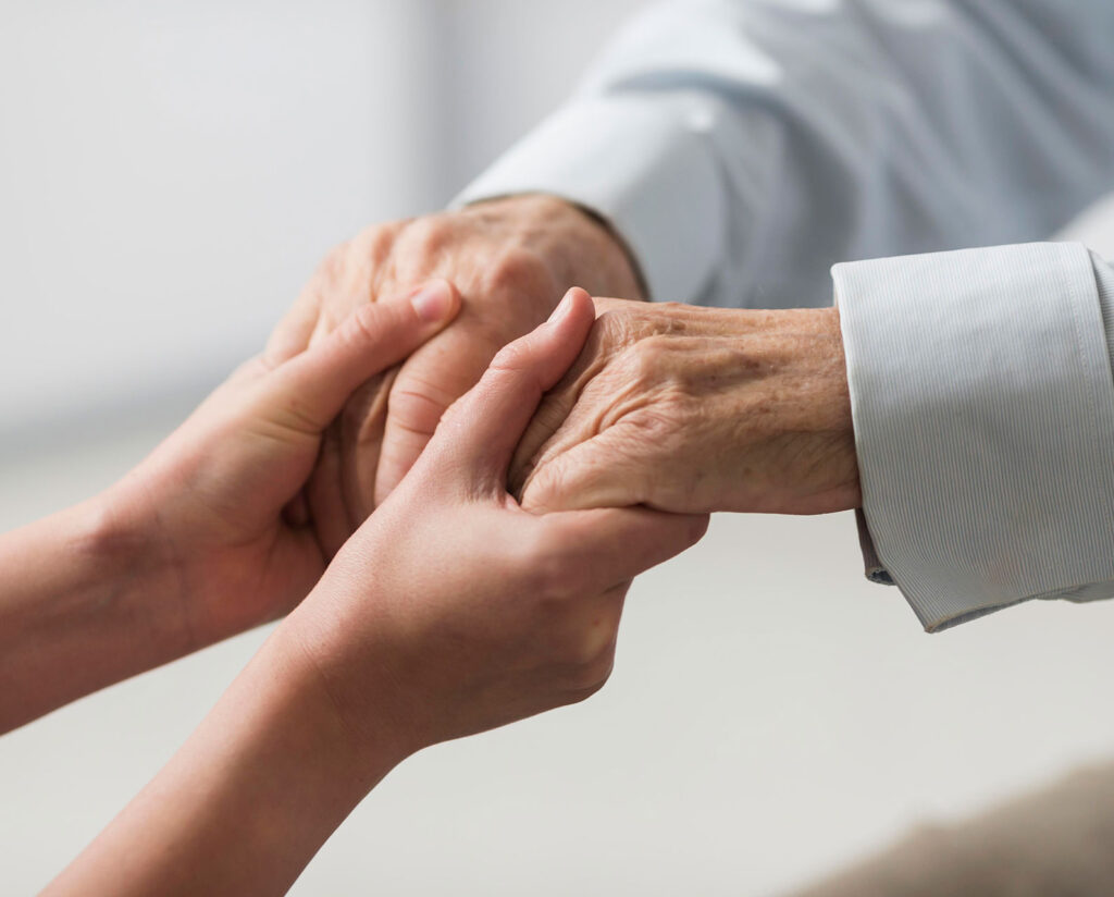 Young hands holding older hands