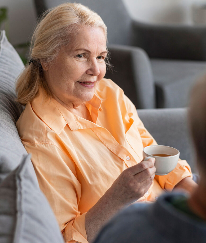 Elderly woman holding teacup