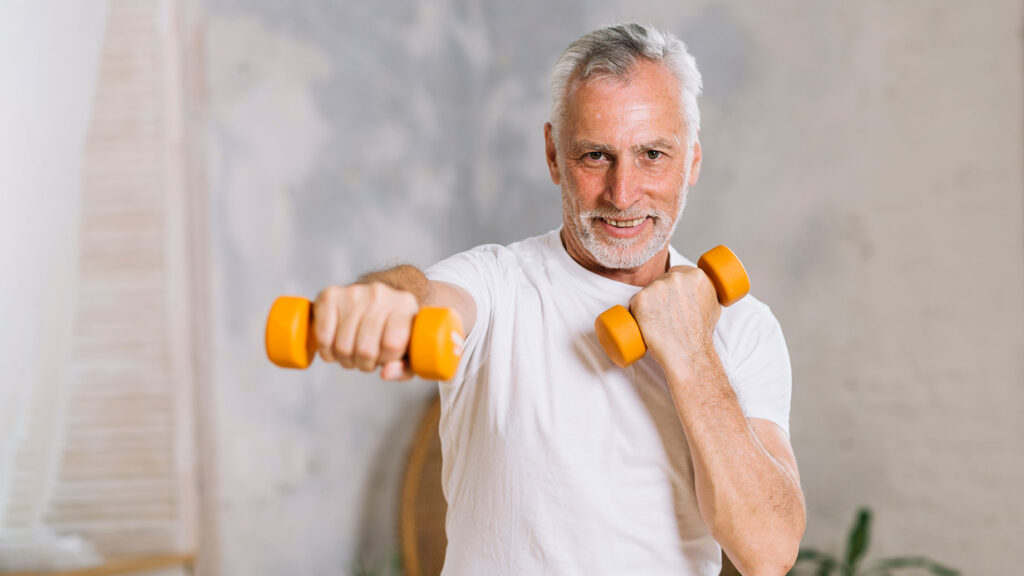 Elderly man holding weights